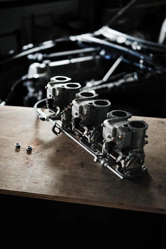 Three carburetors arranged on the workshop bench
